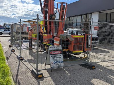 Image showing drilling machinery behind temporary fencing